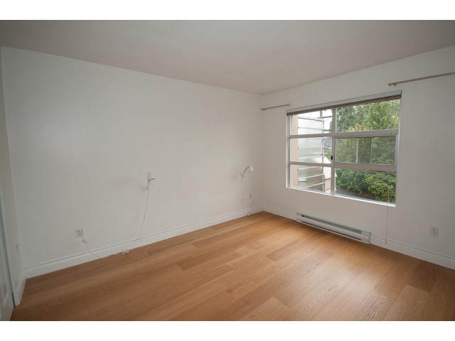 Bright living room with hardwood floors and a city view. - 409 - 3023 West 4th Ave., Vancouver West Side