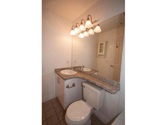 Bright bathroom with granite countertops and a modern light fixture. - 409 - 3023 West 4th Ave., Vancouver West Side