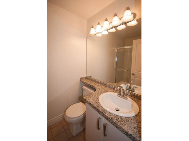 Bright bathroom with granite countertops and a modern vanity. - 409 - 3023 West 4th Ave., Vancouver West Side