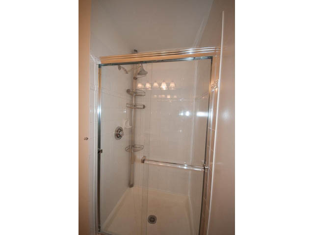 Bright bathroom with glass shower and chrome fixtures. - 409 - 3023 West 4th Ave., Vancouver West Side