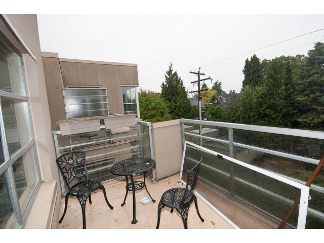 Furnished balcony with black metal chairs and table, city view. - 409 - 3023 West 4th Ave., Vancouver West Side