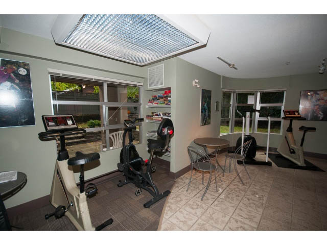 Bright and airy home gym with exercise equipment, large windows, and a ceiling fan. - 409 - 3023 West 4th Ave., Vancouver West Side