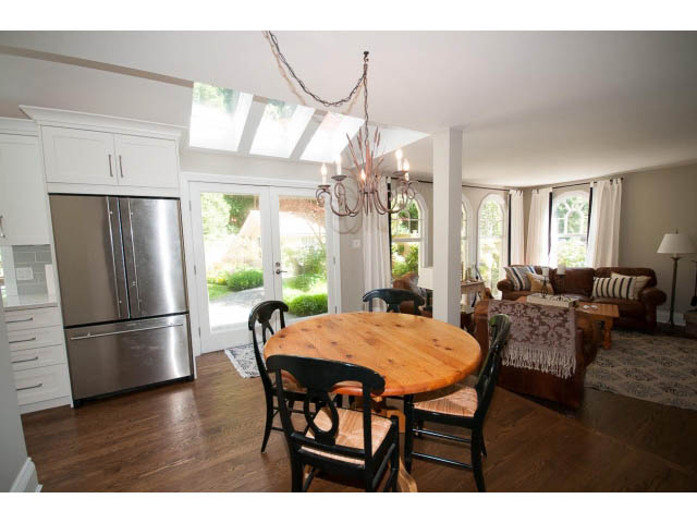 Bright kitchen with stainless steel appliances, hardwood floors, and a skylight. - 3364 Redfern Pl., North Vancouver