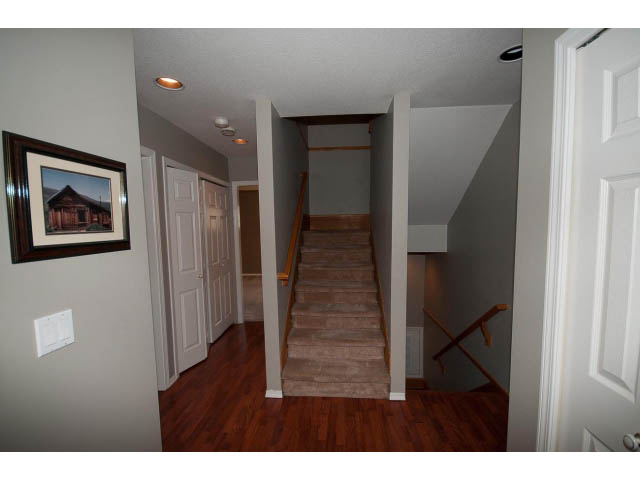 Living room with hardwood floors and a staircase leading to the second floor. - 3 - 260 East 4th St, North Vancouver