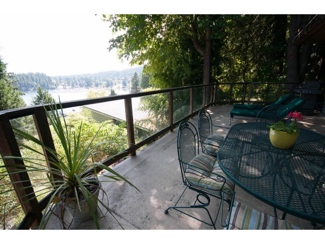 Furnished patio with outdoor furniture, greenery, and a scenic view of the water. - 2795 Panorama Drive, North Vancouver