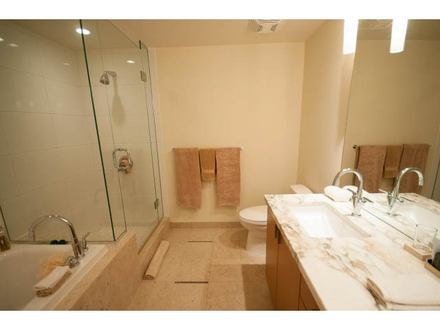 Furnished bathroom with marble countertops and a glass-enclosed shower. - 2604 - 1205 W Hastings St, Vancouver Downtown