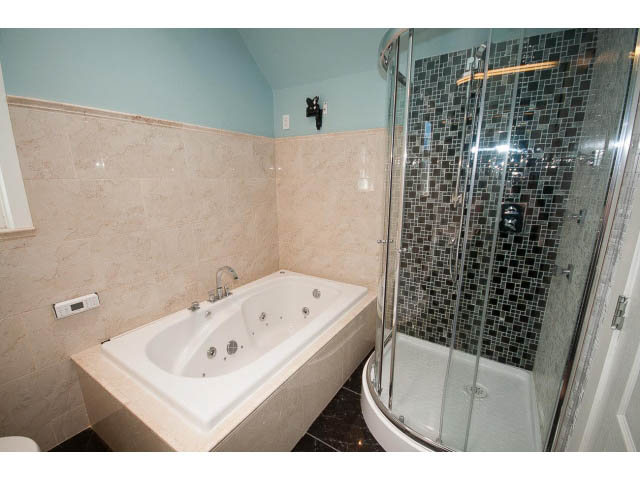 Furnished bathroom with marble countertops and glass shower enclosure. - 3939 West 11th Ave, Vancouver West Side