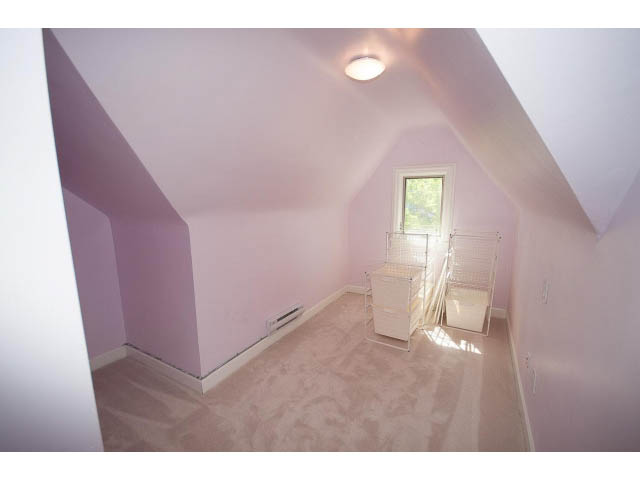 Bright attic bedroom with sloped ceiling and window. - 3939 West 11th Ave, Vancouver West Side