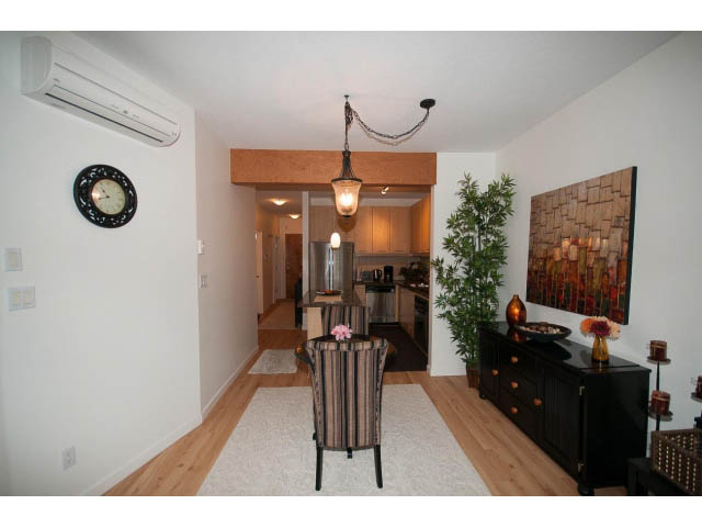 Furnished living room with hardwood floors, modern decor, and a cozy ambiance. - 411 - 560 Ravenwoods Dr., North Vancouver