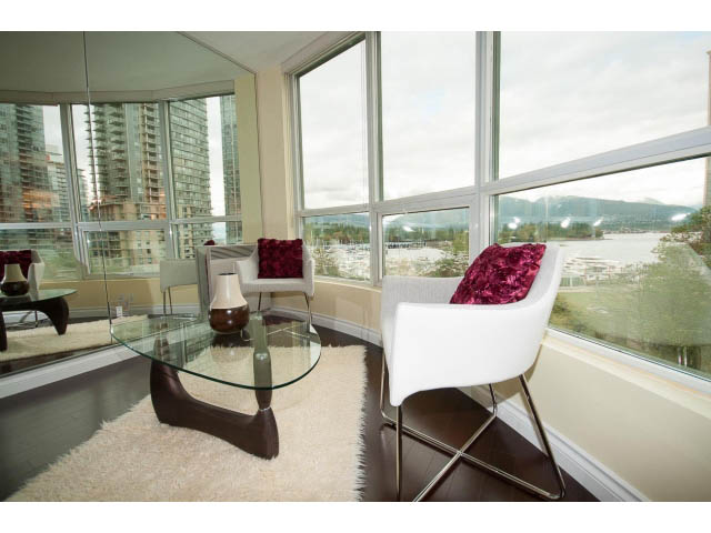 Bright living room with modern furniture, city view, and large windows. - 502 - 555 Jervis, Vancouver Downtown