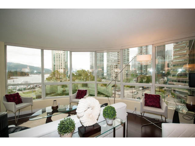 Spacious living room with large windows, city view, and modern furnishings. - 502 - 555 Jervis, Vancouver Downtown