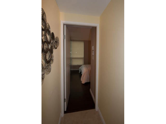 Furnished hallway leading to a bedroom with a decorative wall piece. - 502 - 555 Jervis, Vancouver Downtown