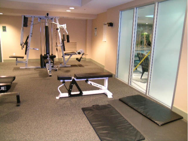 Fitness room with exercise equipment and mats, large windows with city view. - 502 - 555 Jervis, Vancouver Downtown