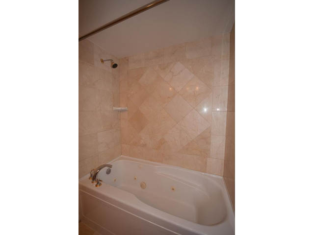 Bathroom with marble tiles and a bathtub. - 3405-1111 W Pender, Vancouver Downtown