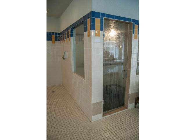 Spacious bathroom with glass shower and blue accent tiles. - 3405-1111 W Pender, Vancouver Downtown