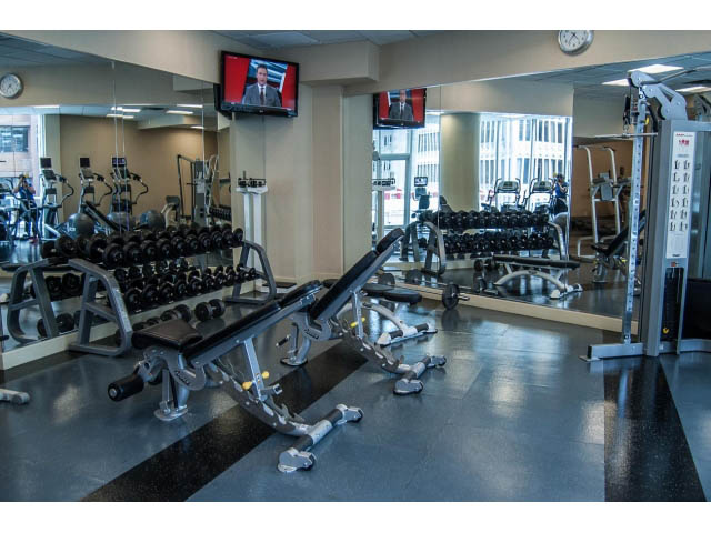 Furnished gym with weight machines and mirrors, city view. - 3405-1111 W Pender, Vancouver Downtown
