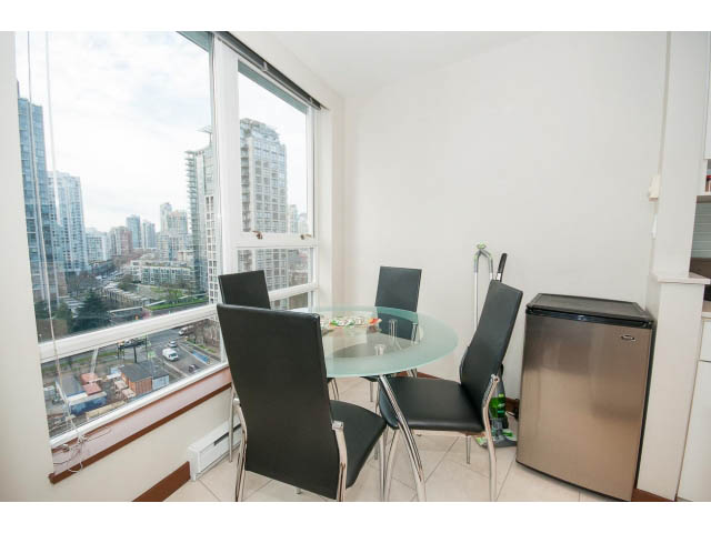 Furnished dining area with city view and modern glass table. - 1702 - 928 Beatty Street, Vancouver Downtown