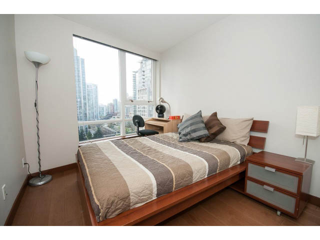 Bright bedroom with city view, modern furnishings, and hardwood floors. - 1702 - 928 Beatty Street, Vancouver Downtown