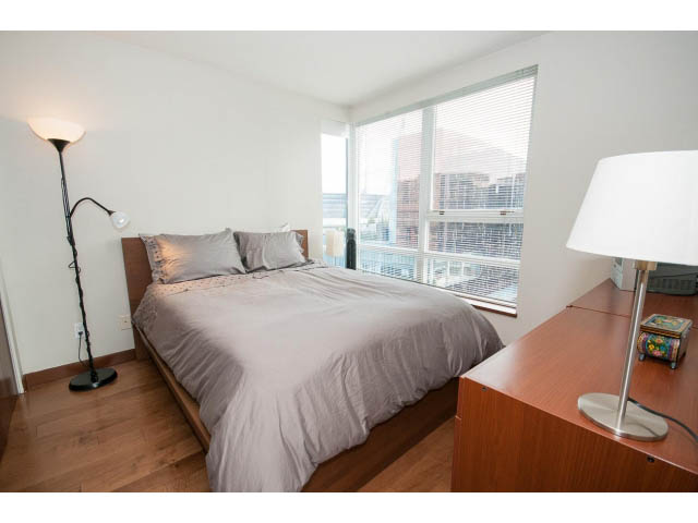 Furnished bedroom with hardwood floors, city view, and modern furniture. - 1702 - 928 Beatty Street, Vancouver Downtown