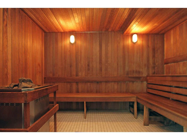 Spacious sauna with wooden benches and rock heater. - 1702 - 928 Beatty Street, Vancouver Downtown