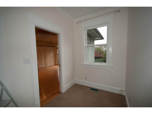 Bright living room with hardwood floors and large window view. - 3362 West 3rd Ave, Vancouver West Side