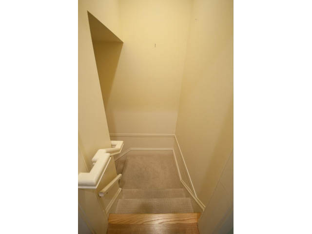 Staircase leading to upper floor with carpeted steps and white walls. - 3362 West 3rd Ave, Vancouver West Side
