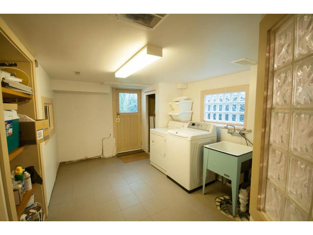 Bright laundry room with white appliances and tiled floor. - 3362 West 3rd Ave, Vancouver West Side