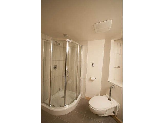 Bright bathroom with walk-in shower and modern toilet. - 3362 West 3rd Ave, Vancouver West Side