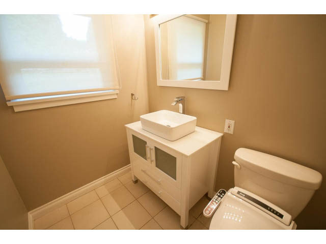 Bright bathroom with white countertop and toilet, clean and minimalistic design. - 555 Stevens Dr, West Vancouver