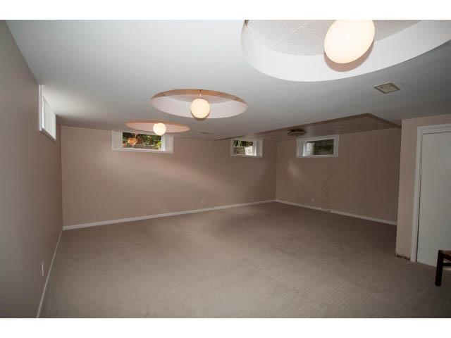 Spacious basement with recessed lighting and small windows. - 555 Stevens Dr, West Vancouver