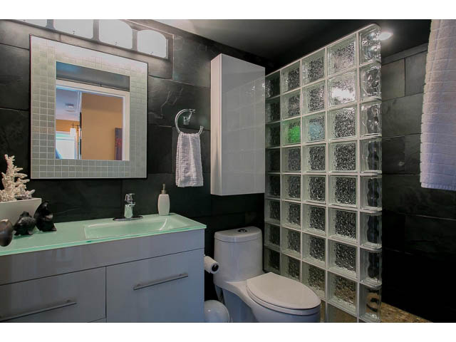 Modern bathroom with glass block wall and sleek countertop. - 1505 - 488 Helmcken, Vancouver Downtown