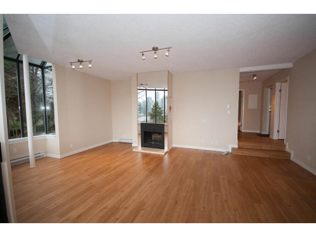 Open-concept living space with hardwood floors and a city view. - 14 - 1201 Lamey's Mill Rd., Vancouver West Side