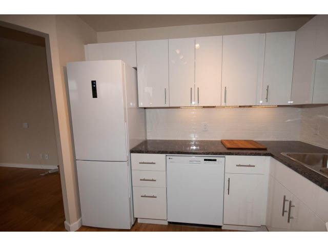 Bright kitchen with white cabinets, granite countertops, and hardwood floors. - 14 - 1201 Lamey's Mill Rd., Vancouver West Side