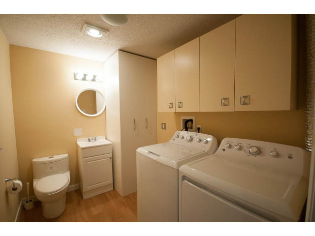 Bright bathroom with white fixtures and wooden floors. - 14 - 1201 Lamey's Mill Rd., Vancouver West Side