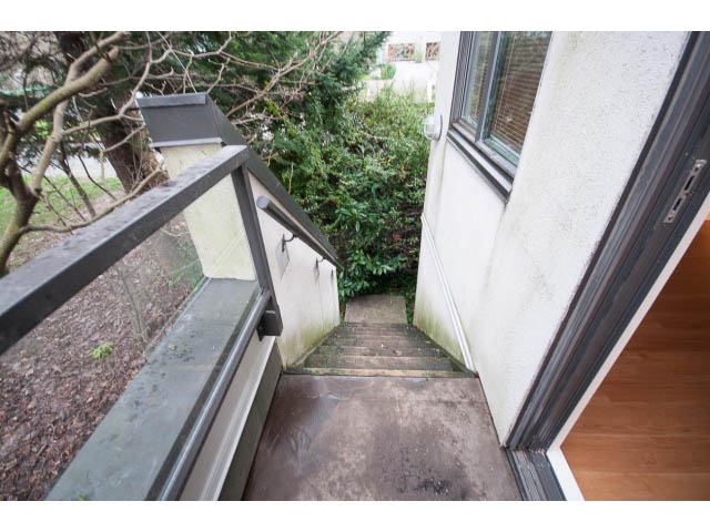 Balcony with metal railing and view of greenery. - 14 - 1201 Lamey's Mill Rd., Vancouver West Side