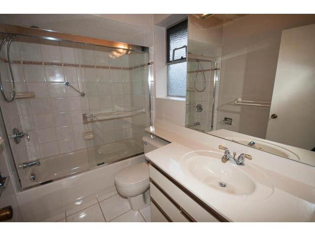 Bathroom with white countertop, sink, and glass shower. - 610 Newdale Rd., West Vancouver