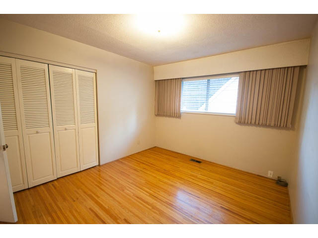 Bright bedroom with hardwood floors and large window, natural light streaming in. - 610 Newdale Rd., West Vancouver