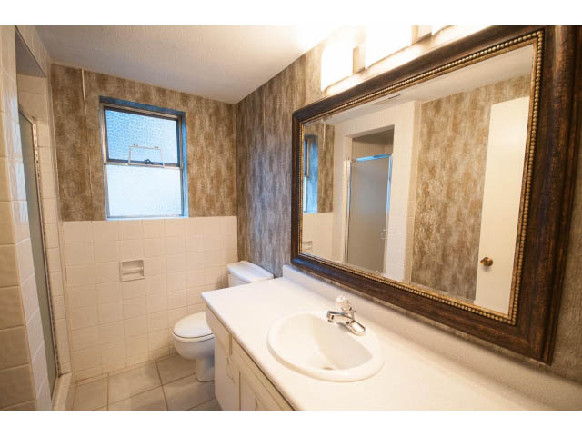 Furnished bathroom with white countertop and large mirror. - 610 Newdale Rd., West Vancouver