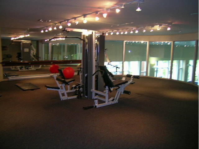 Bright gym with cardio equipment and large windows, carpeted floor. - 708 - 193 Aquarius Mews, Vancouver Downtown