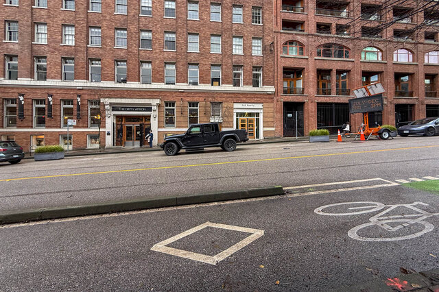 Loft with brick facade, modern furnishings, and a view of the street. - 308 - 546 Beatty Street, Vancouver Downtown