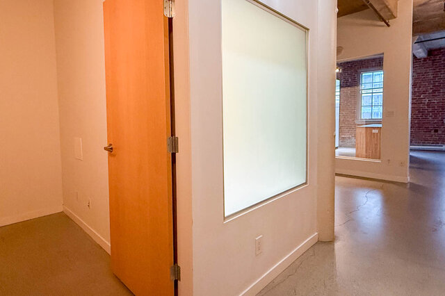 Spacious loft with polished concrete floors and a modern sliding door. - 308 - 546 Beatty Street, Vancouver Downtown