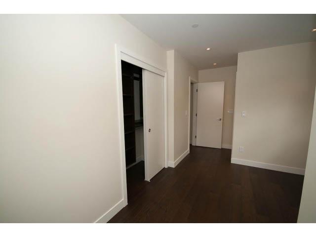 Spacious living room with hardwood floors and a sliding door leading to another room. - 2895 Balaclava St., Vancouver West Side