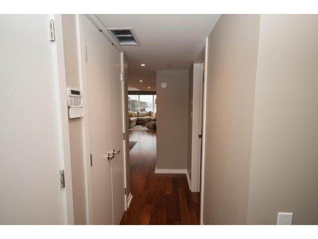 Furnished hallway with hardwood floors and a view of the living area ahead. - 901 - 1690 West 8th Ave, Vancouver West Side