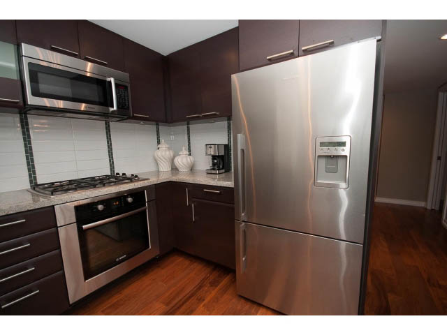 Bright kitchen with stainless steel appliances, granite countertops, and hardwood floors. - 901 - 1690 West 8th Ave, Vancouver West Side