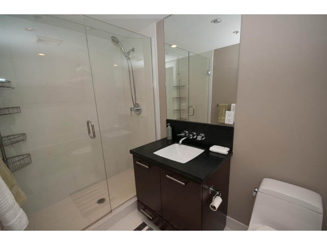 Furnished bathroom with dark wood vanity, glass shower, and modern fixtures. - 901 - 1690 West 8th Ave, Vancouver West Side
