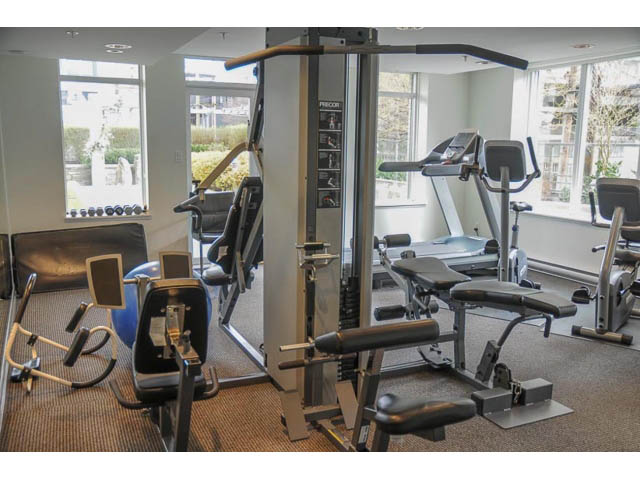 Bright gym with cardio and weight machines, large windows. - 901 - 1690 West 8th Ave, Vancouver West Side
