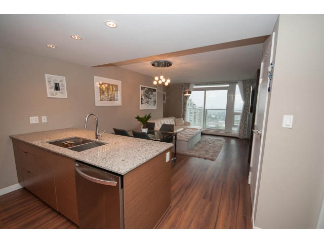 Bright kitchen with granite countertops, hardwood floors, and a city view. - 1602 - 135 East 17th Street, North Vancouver