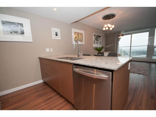 Bright kitchen with granite countertops, hardwood floors, and a city view. - 1602 - 135 East 17th Street, North Vancouver