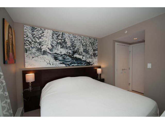 Bright bedroom with white bedding and a large snowy forest mural above the bed. - 1602 - 135 East 17th Street, North Vancouver