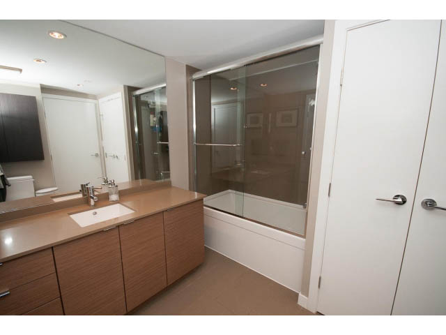 Furnished 1-bedroom condo with modern white cabinetry and sleek countertop. - 1602 - 135 East 17th Street, North Vancouver
